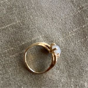 14K gold ring.  4.46 grams.  Not sure what stone? Maybe white Star Sapphire??